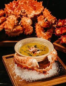 Luxurious presentation of crab dish served with rich sauce, perfect for gourmet dining.